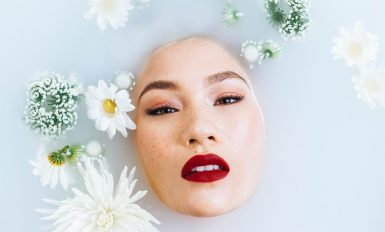 femme sous l'eau visage qui sort avec fleurs qui flottent